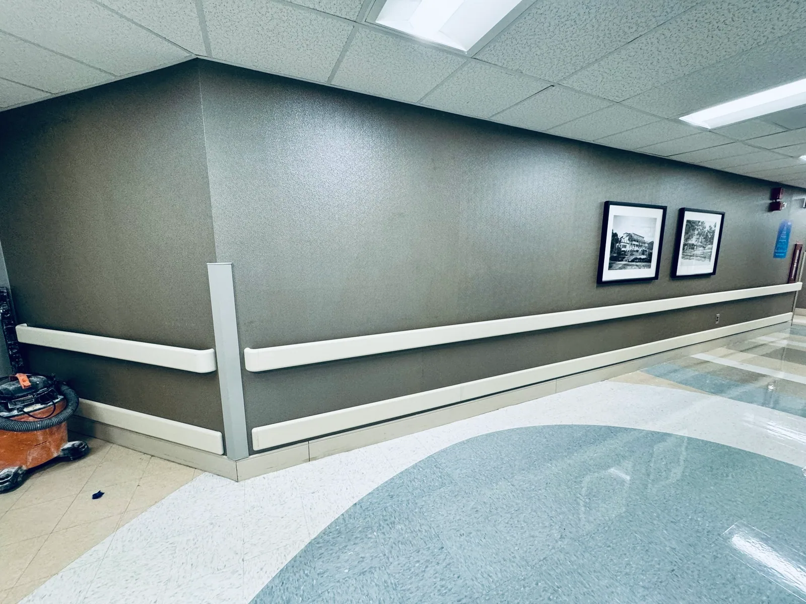 Commercial hallway with wall rails and framed pictures