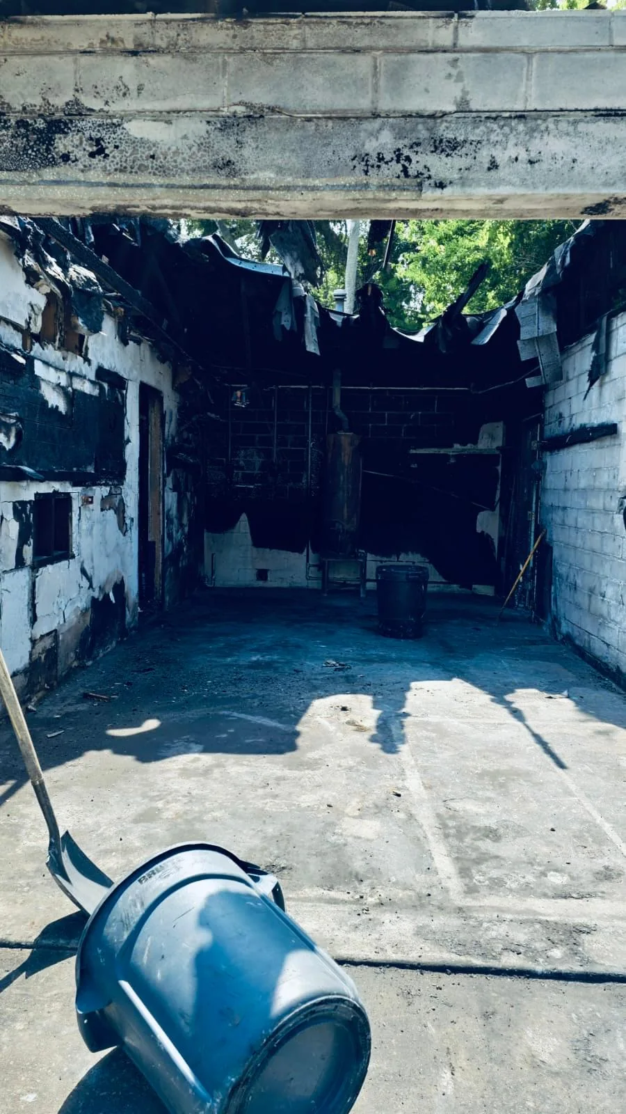Fire-damaged room with an air mover in the foreground