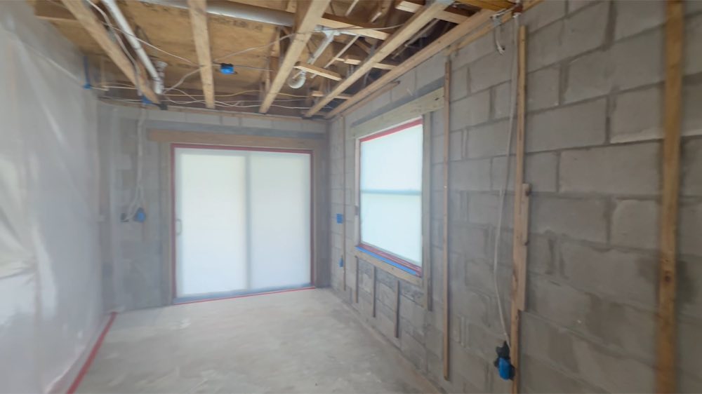 Room with exposed ceiling joists and block walls
