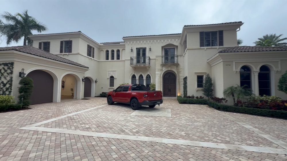 Large home with a paved courtyard