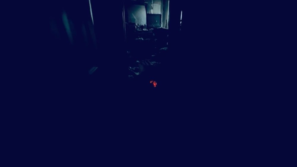 Dark room with an opening visible in the background
