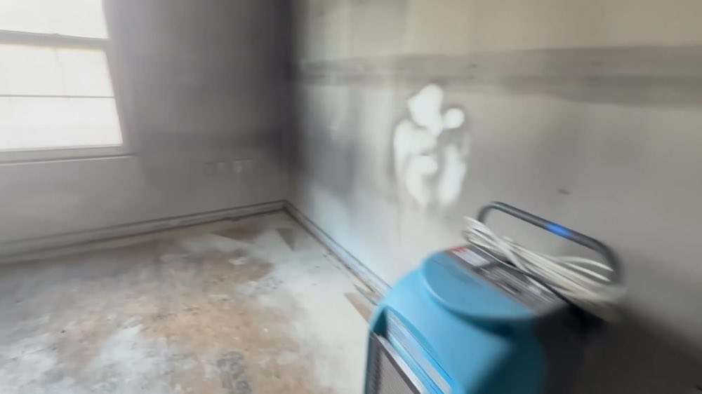 Drying equipment beside a stained wall