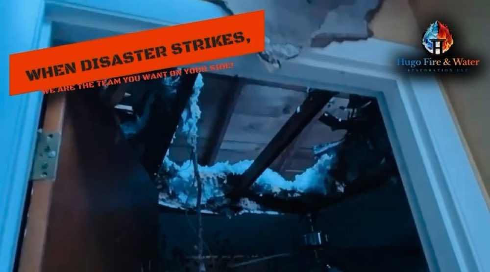 Fire-damaged ceiling with a Hugo restoration message