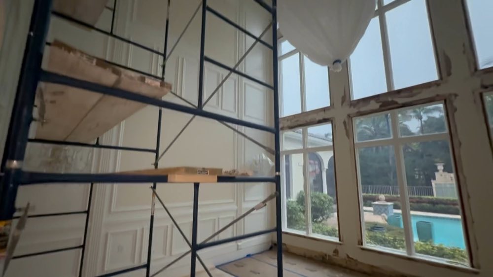 Scaffolding beside a bank of tall windows