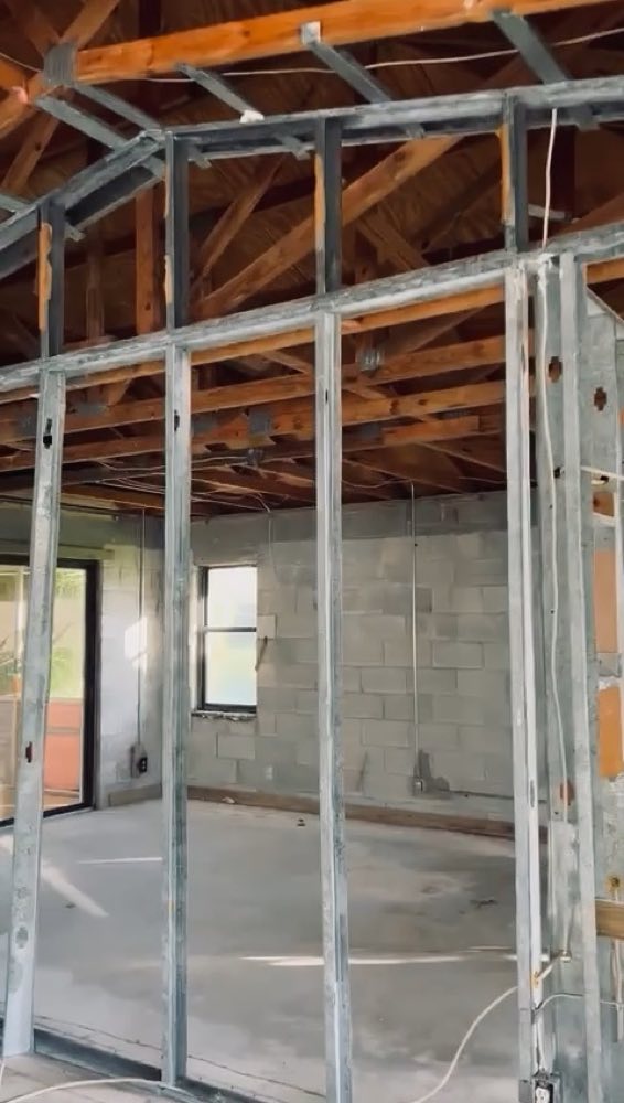 Exposed studs and overhead framing inside a building