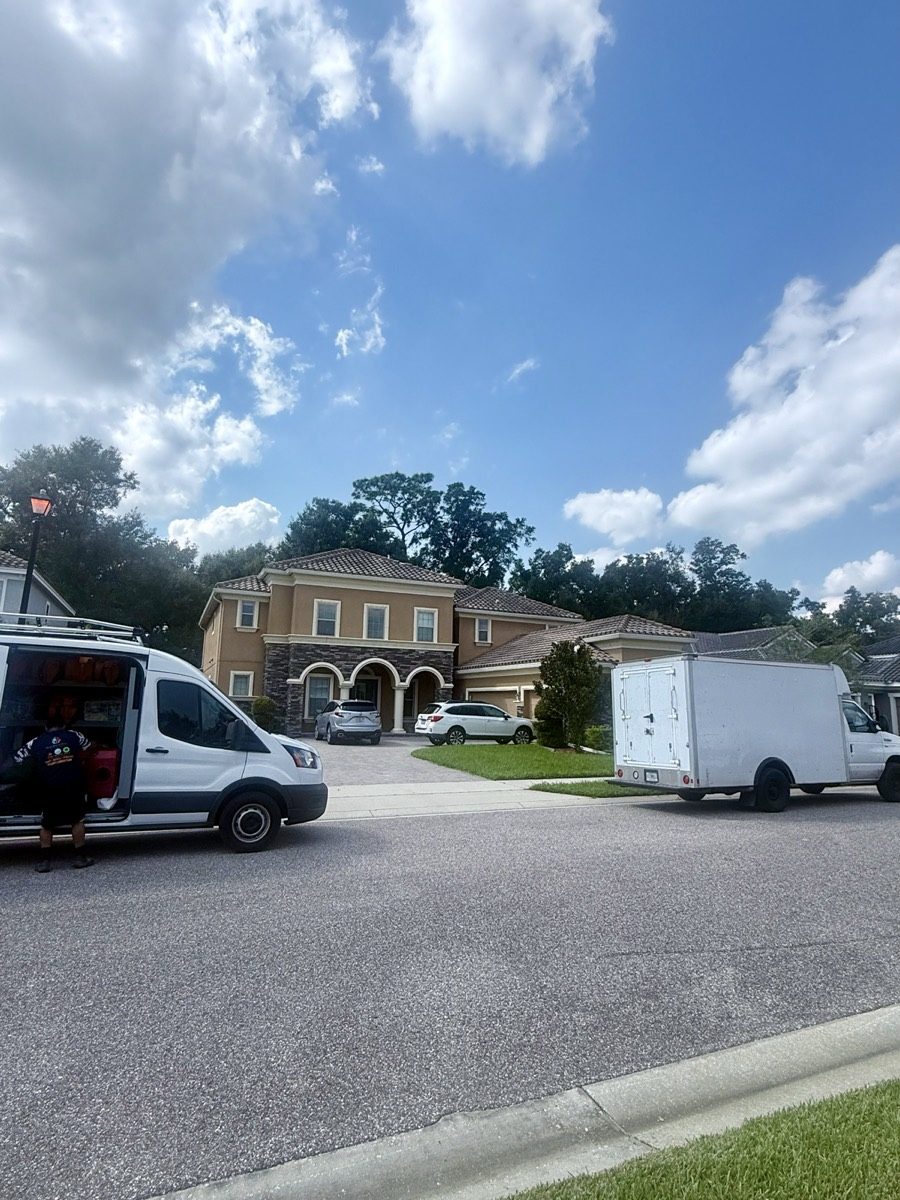 Service vehicle and trailer parked outside a home